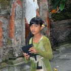 Little girl steps out the temple of Puri Agung Dalem Tarukan