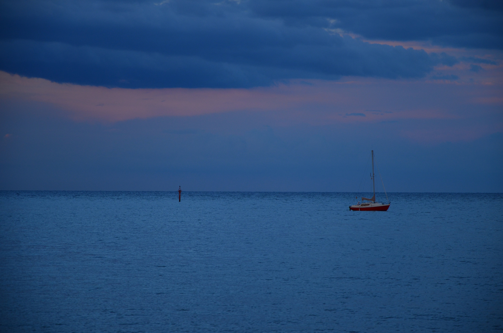 Little red boat in the sea