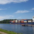 little yacht meeting a cargo vessel on a sunny day