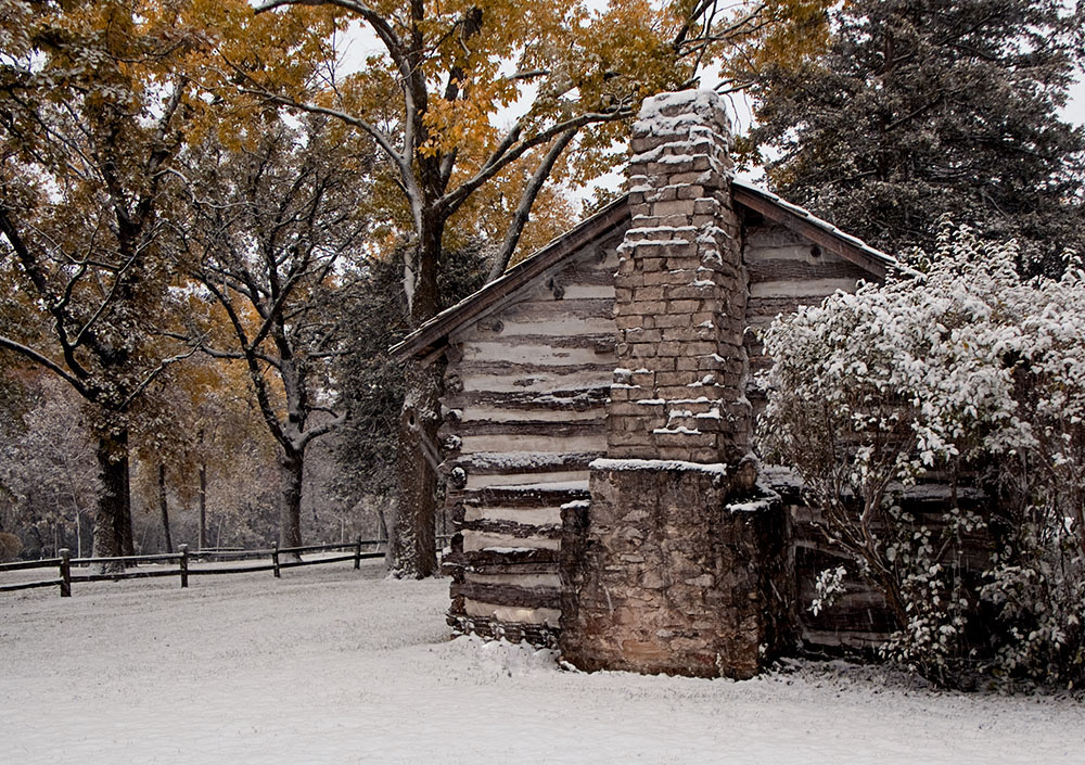 Log cabin in snow storm