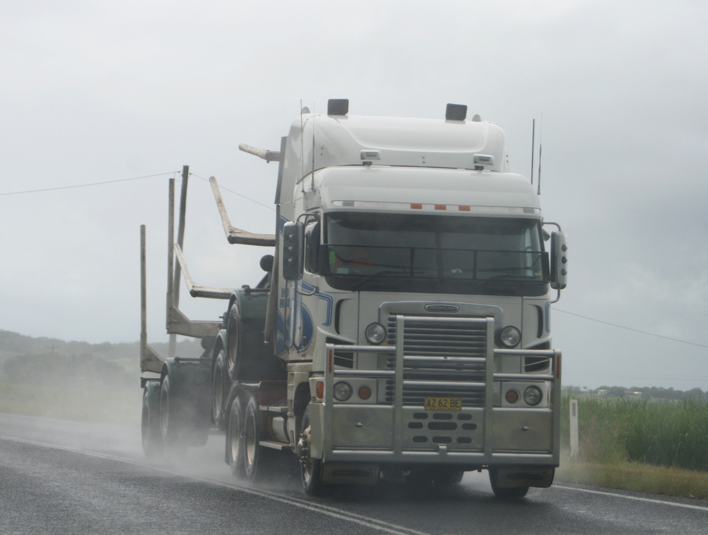 logging truck in the rain on the highway