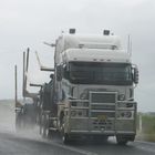 logging truck in the rain on the highway