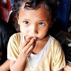 Lombok: yummy, little boy eating snake fruit.