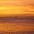 Lone boat i a red, red sun