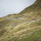 Lone hikers at rolling mountains of Penser Joch