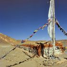 Long mani wall and a prayer flag in Tholing