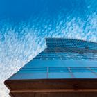 Looking up a high rise building which resembles a cruise ship