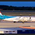 Luxair Dash 8-Q402 by night