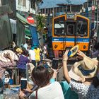 Maeklong railway through the market