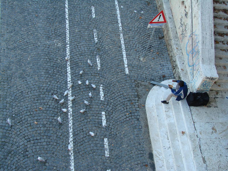 man & pigeons, eating.