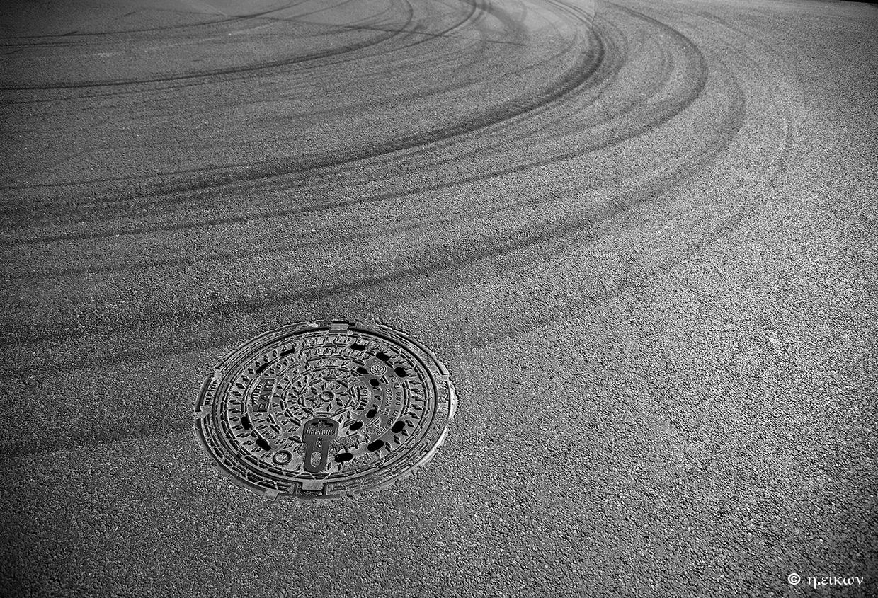 manhole cover and asphalt traces