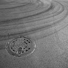 manhole cover and asphalt traces