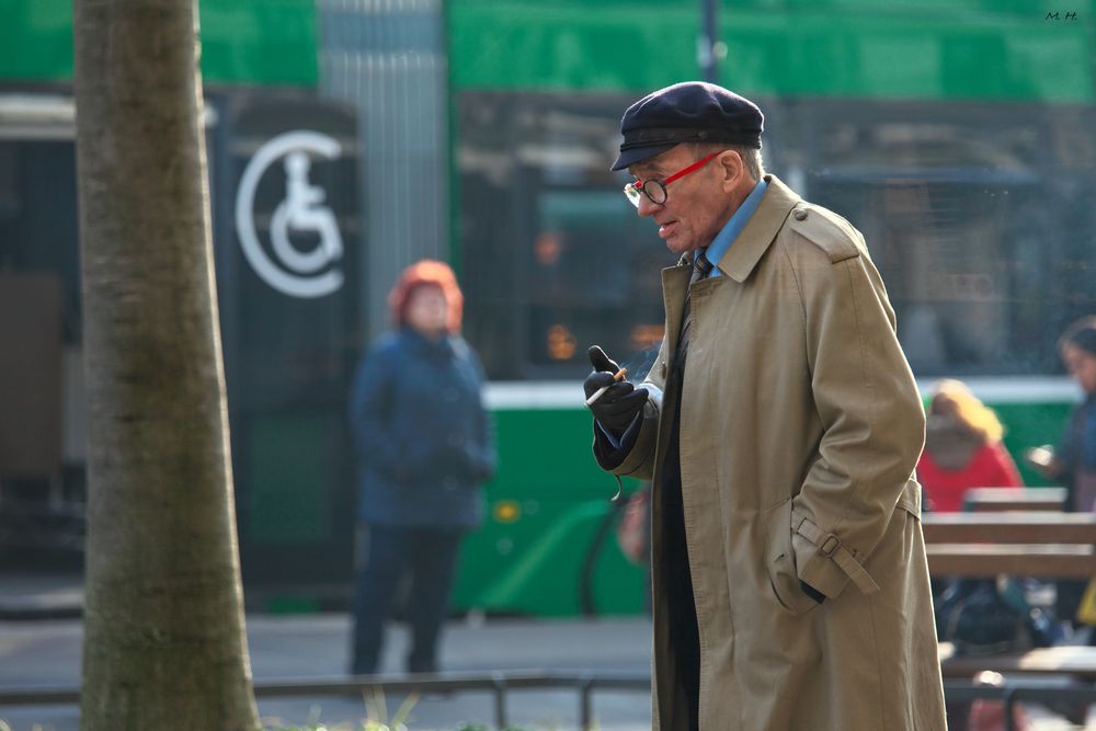 Mann mit roter Brille und Zigarette