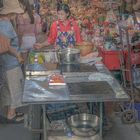 Market woman selling Khanom