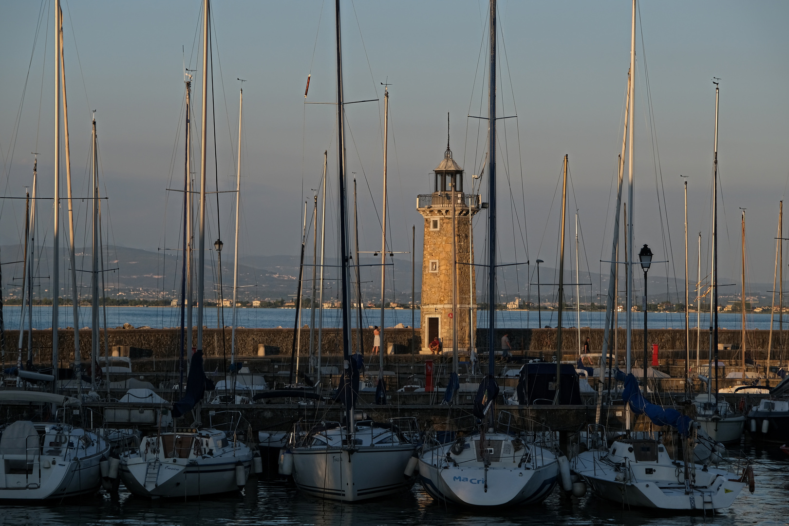 Masten und ein Leuchtturm im Abendlicht