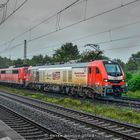 MEG 159 235 mit ausgemusterten Fahrzeugen gen West