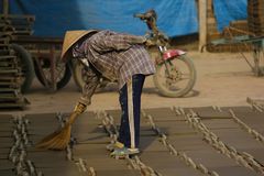 Mekong, Arbeiterin putzt Fliesenrohlinge