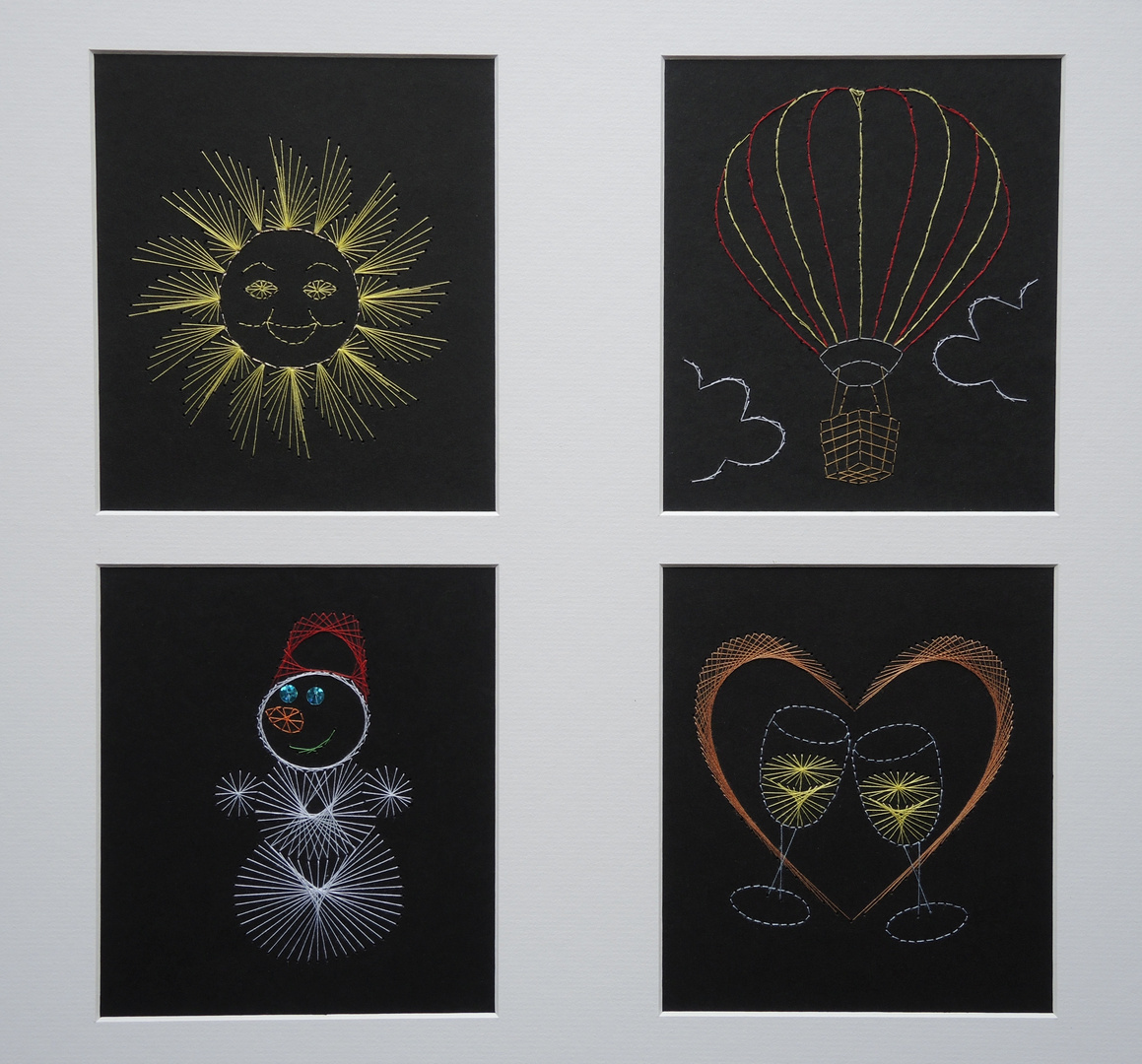 Mit Nadel, farbigem Nähgarn und Pailletten auf schwarzem Tonpapier - Fadenbilder