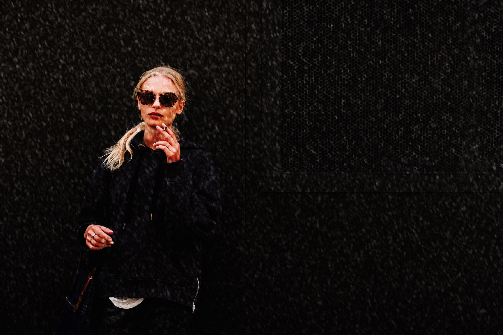 Model waiting under the snow in London Fashion Week