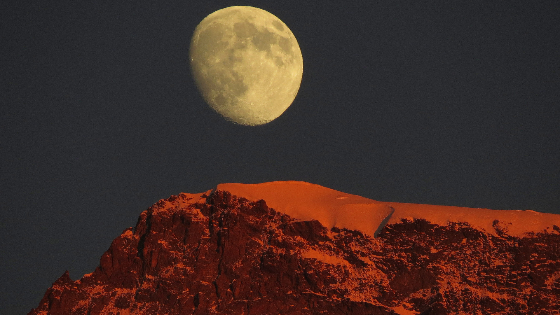 Mond über Bergspitze