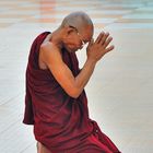 Monk praying to the Buddha in Botataung Pagoda in Rangoon