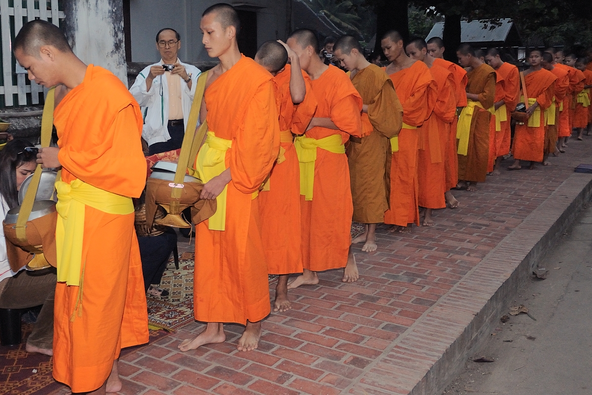 Monks get food donation in early morning