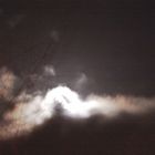 moon - her striking beauty embraced by loving clouds