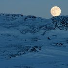 Moon over arctic landscape