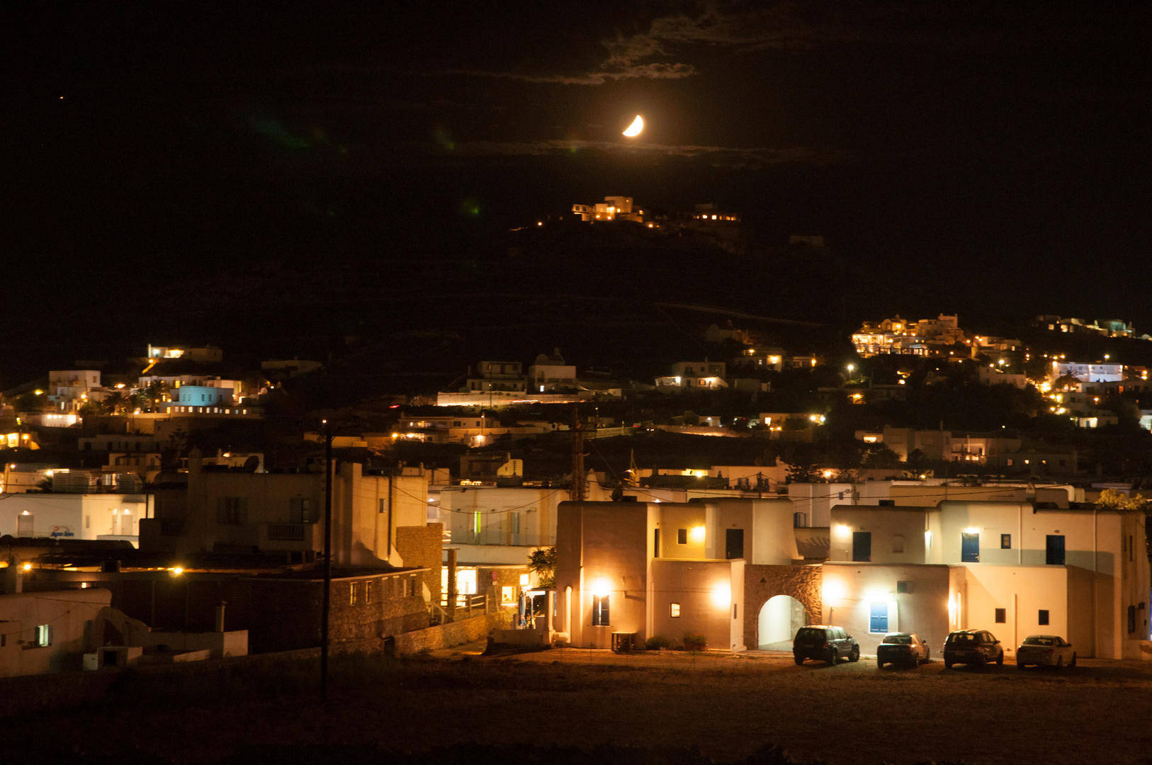 Moon setting over ornos town in Mykonos 