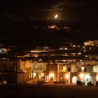 Moon setting over ornos town in Mykonos 