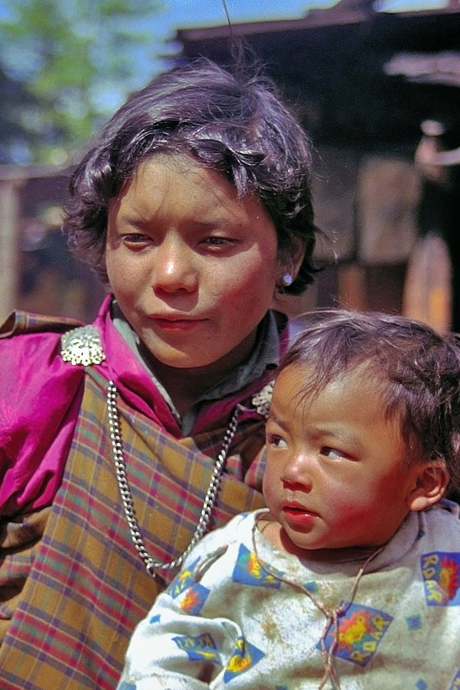 Mother and son join the Paro Tsechu festival