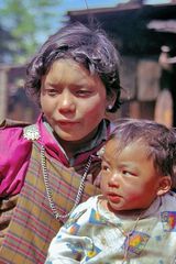 Mother and son join the Paro Tsechu festival