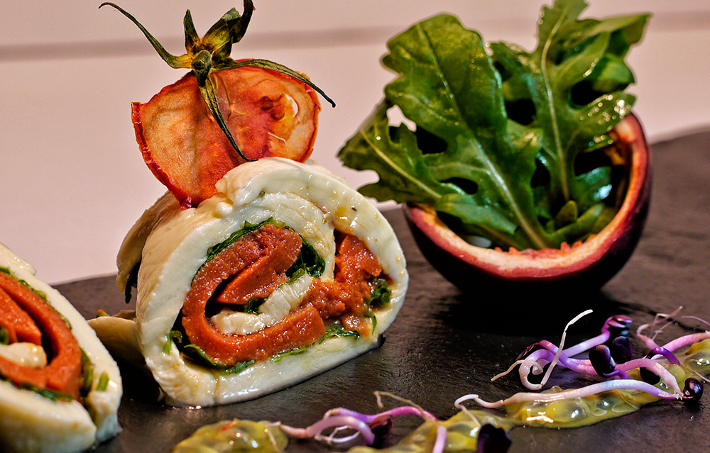 Mozzarella-Rolle mit Tomatenpaste und Rucola