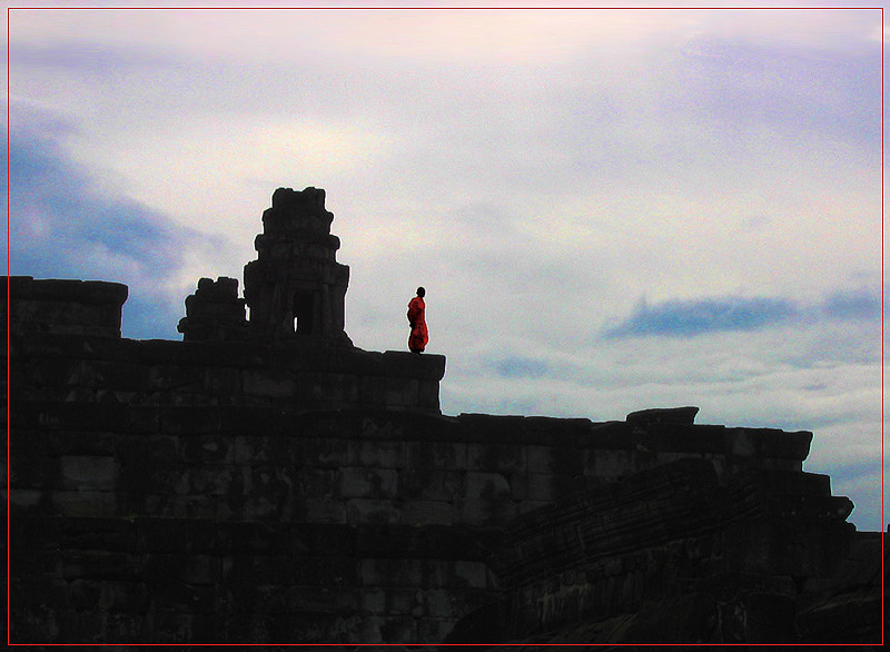 Munk on a temple at sunset