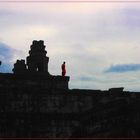 Munk on a temple at sunset