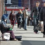 Musikantenjunge vor frontal kommenden Passanten vor Tabakladen und Metroeingang auf der Tverskaja