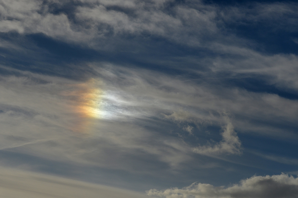 Nebensonne (Halo) hinter nordischen Wolken