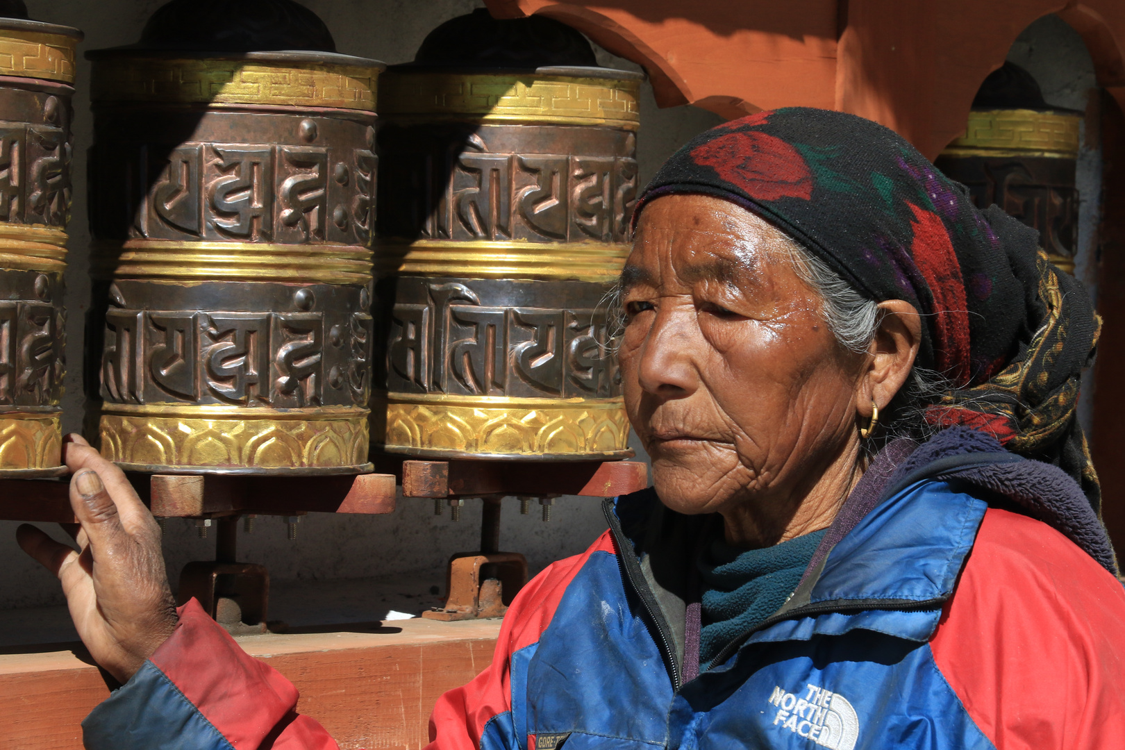 Nepalesin an Gebetsmühlen