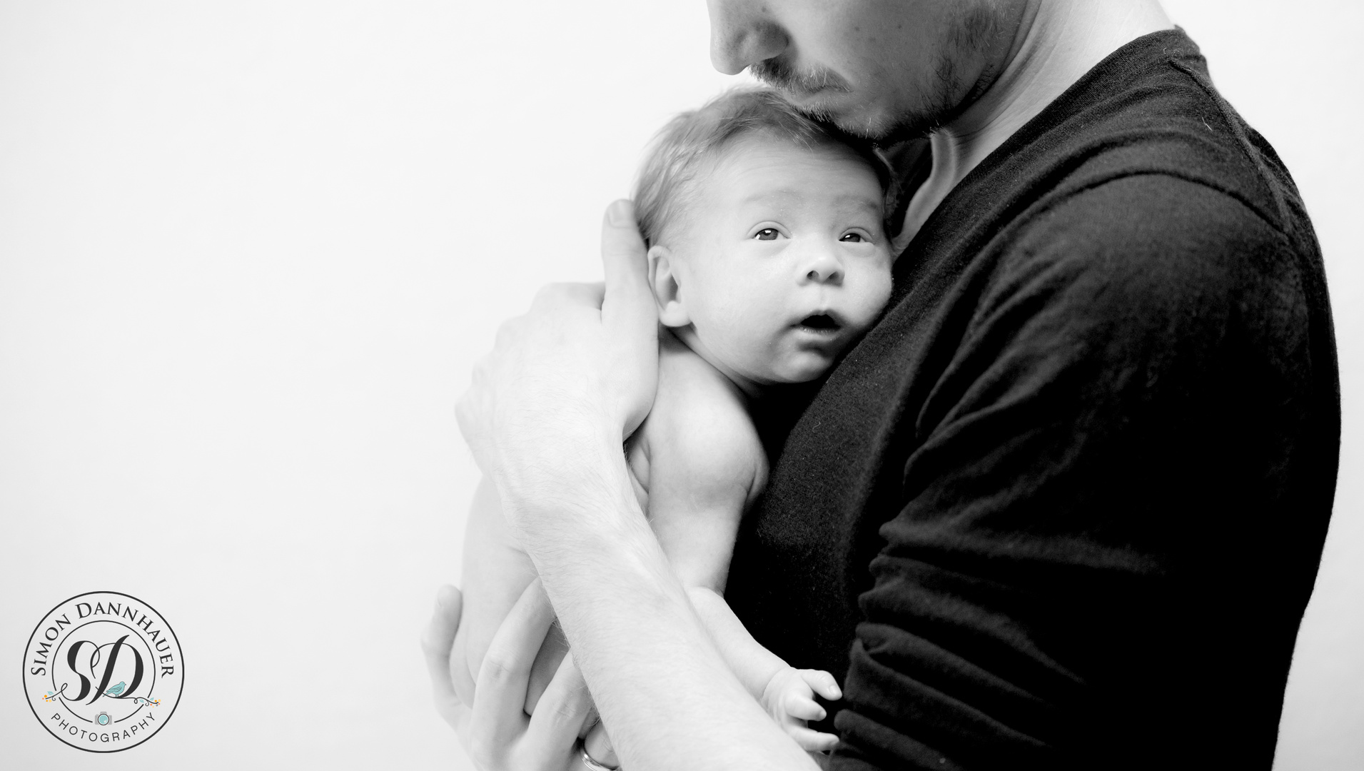 Newborn Baby in Hands of Dad