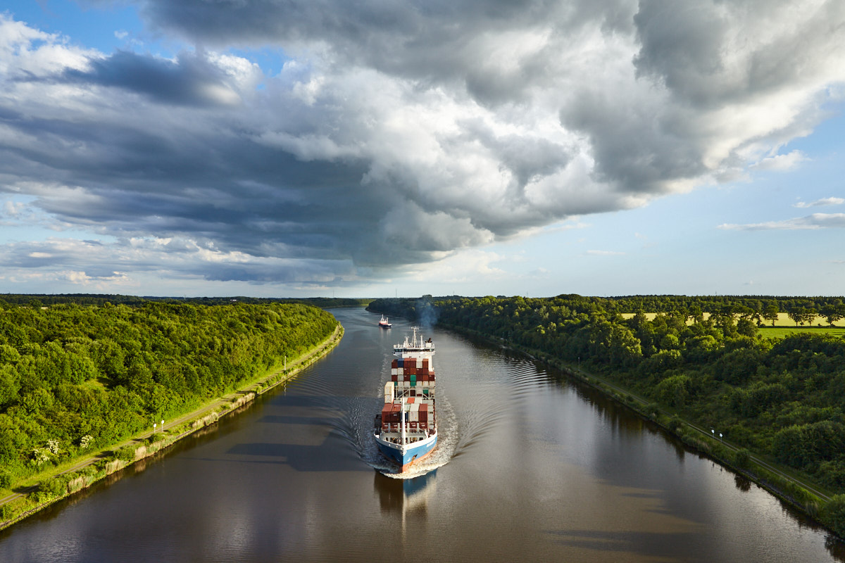 Nord-Ostsee-Kanal mit Wolkenwalze und Containerschiff Elisabeth