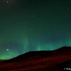 Northern lights dansing on a mountain