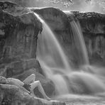 nude photo with a long exposure of a waterfall