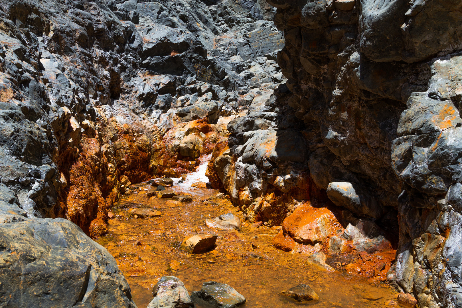 Ockerfarbener Weg durch das Bachbett zur Cascada de Colores