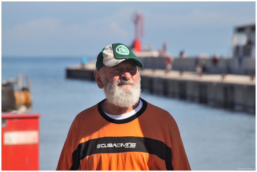 Old fisherman on the dock boat