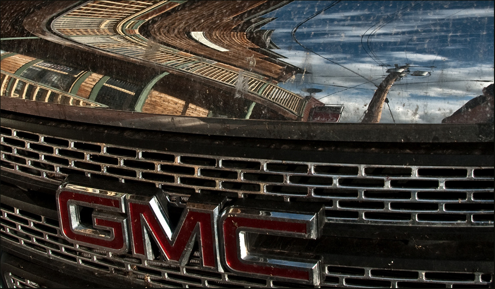 Old Hazelton Reflections in a Modern SUV with Dirt on the Hood