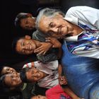 Old indonesian Lady surrounded by Kids