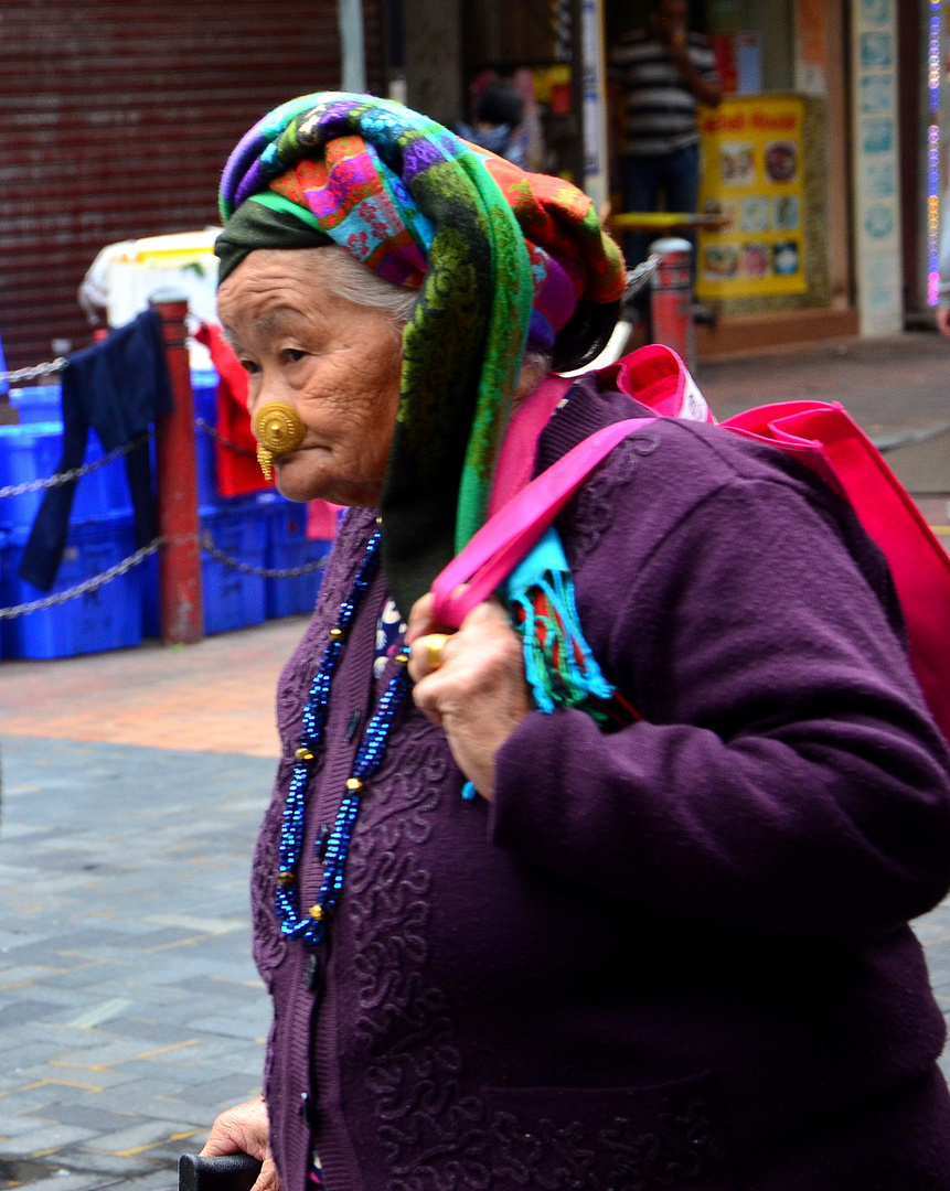 Old lady in traditional clothes - in the streets of Hongkong
