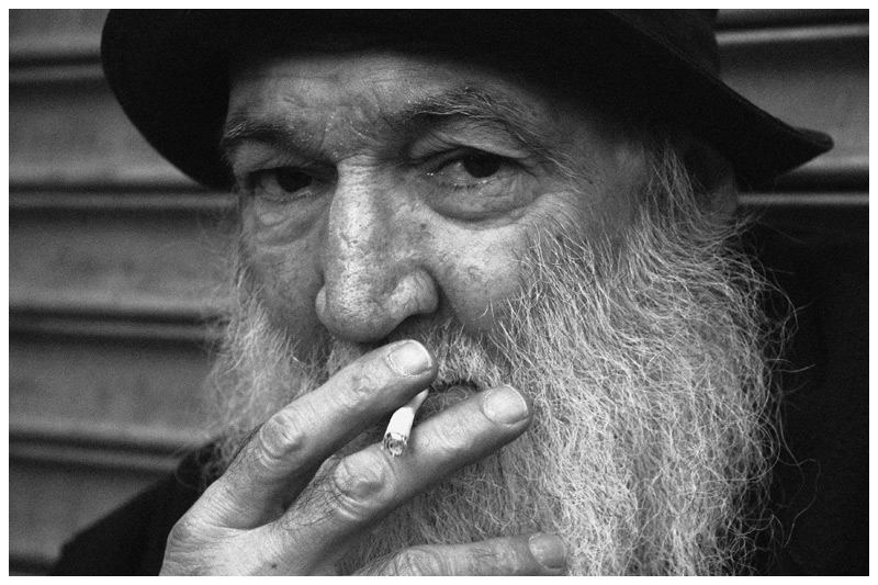 Old man in front of closed down market