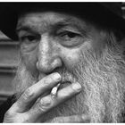 Old man in front of closed down market