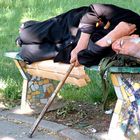 old man taking a nap on a bench...